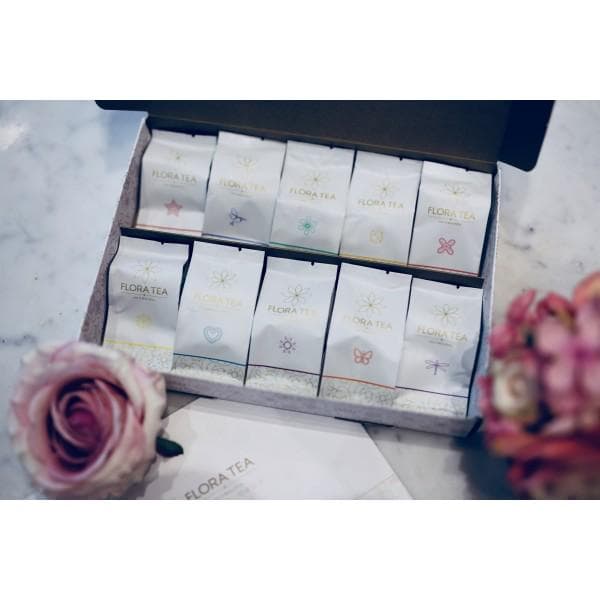 The Full Bloom — all ten Flora Tea hearts arranged in a signature presentation box, surrounded by rose petals