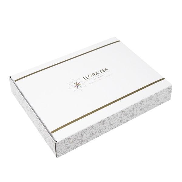 The Full Bloom — all ten Flora Tea hearts arranged in a signature presentation box, surrounded by rose petals